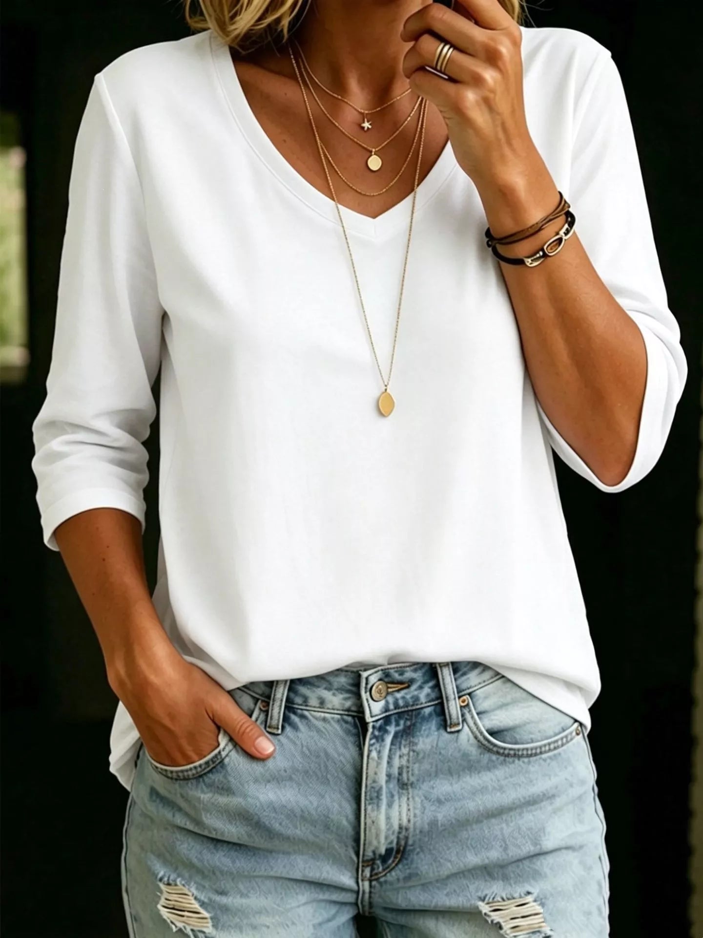 Plus size V-neck 3/4 sleeve T-shirt from Trendsi, stylish and comfortable top with a full-size fit and V-neck design.