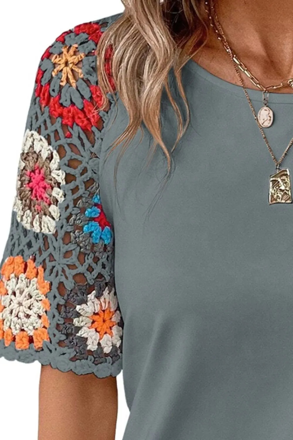 Plush Fashion Hub geometric print round neck short sleeve blouse with stylish design and vibrant patterns, perfect for casual wear.
