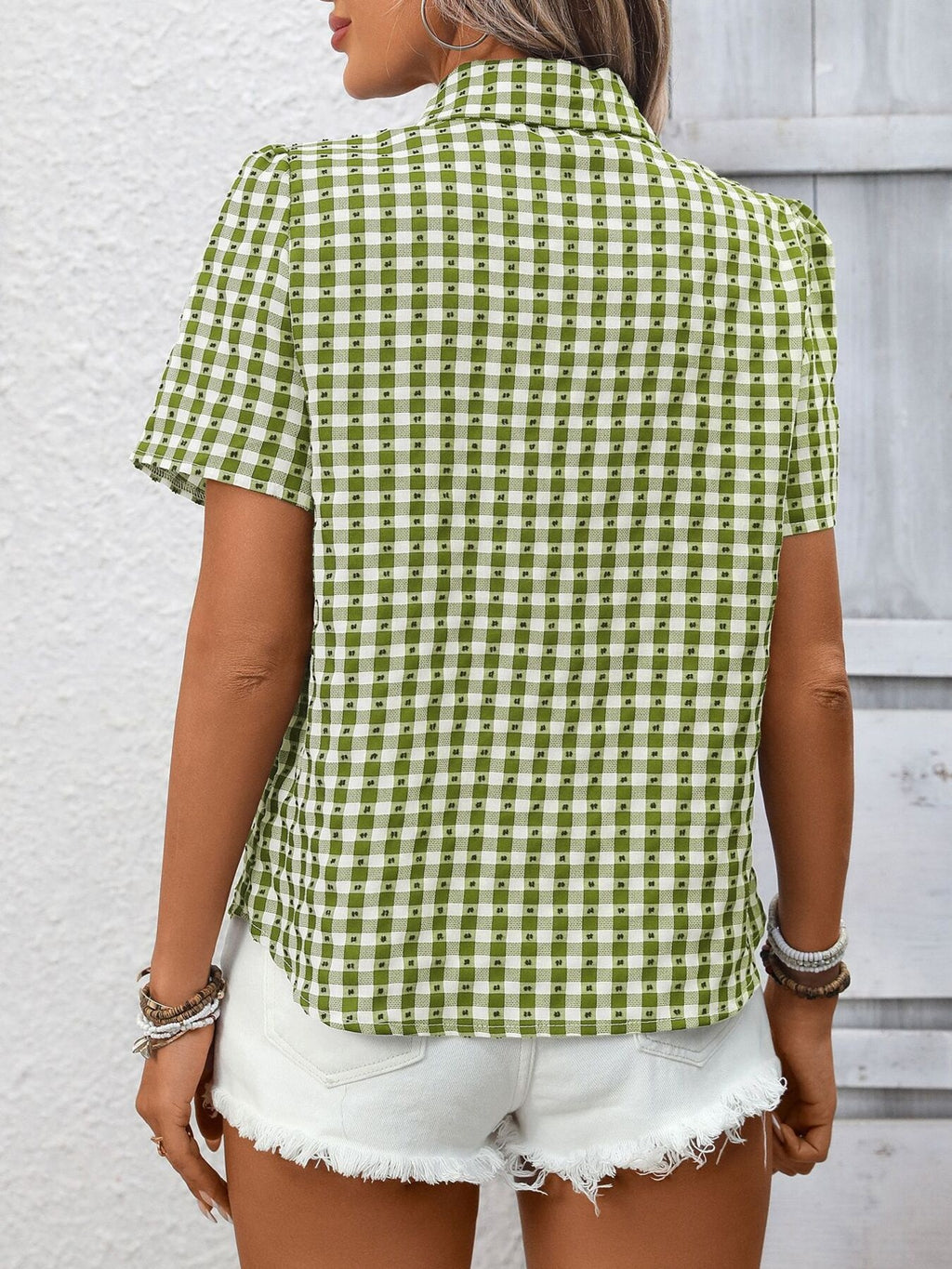 Women's lightweight plaid button-up short sleeve shirt by Trendsi, featuring a classic checkered pattern and casual fit.