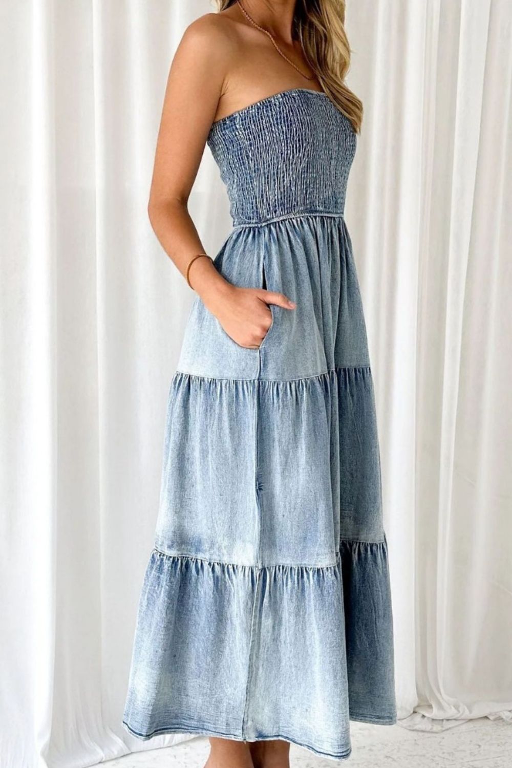 VYSN smocked tube slit tiered denim dress with adjustable straps and ruffled hem, styled for casual summer fashion.