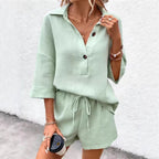 Women's two-piece set by Plush Fashion Hub featuring a notch-lapel short-sleeve top and belted shorts, styled for casual wear.