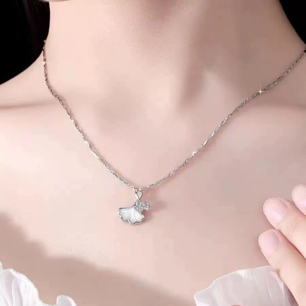 Ginkgo leaf pendant necklace by Shopimist featuring a delicate gold-tone ginkgo leaf charm on a chain.