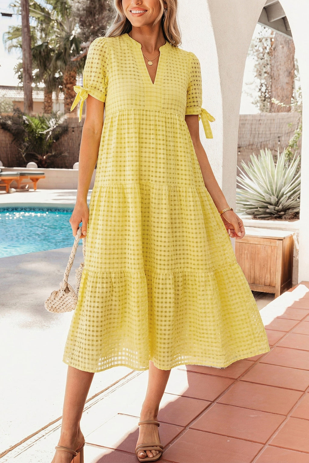 Skyla Sleeve Tiered Midi Dress by Threaded Pear, featuring layered fabric and long sleeves, displayed on a hanger.