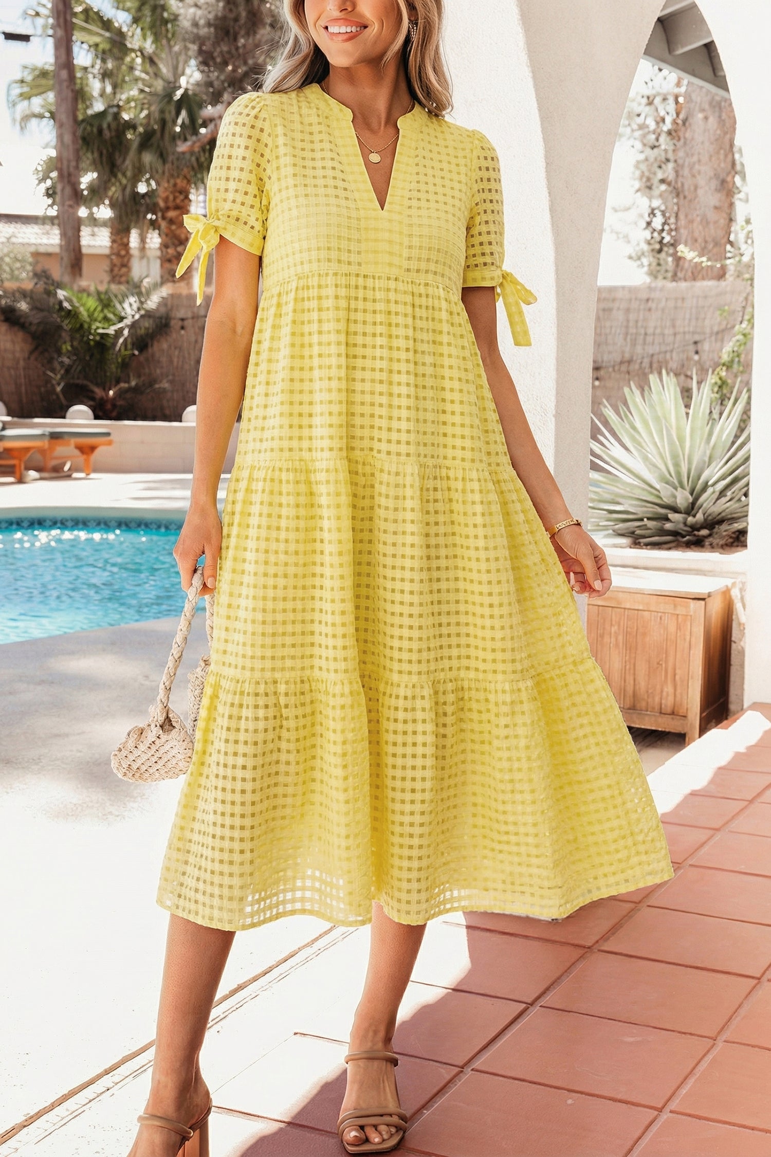 Skyla Sleeve Tiered Midi Dress by Threaded Pear, featuring layered fabric and long sleeves, displayed on a hanger.