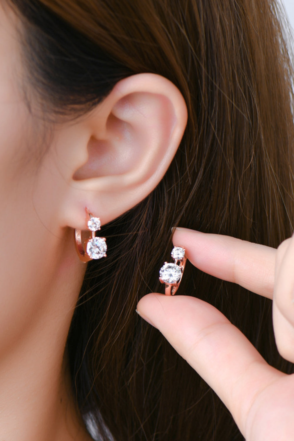 Sterling silver earrings with 1.3 carat moissanite stones, featuring a simple and elegant jewelry design.
