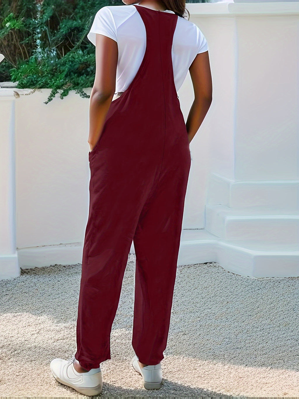 Casual loose fit spaghetti strap jumpsuit with pockets from Trendsi, featuring a relaxed design and lightweight fabric.