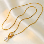 Elegant pearl pendant necklace featuring a single white pearl on a delicate chain, showcasing classic jewelry style.