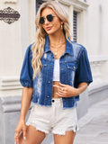 VYSN distressed raw hem button-up denim jacket with frayed edges and classic fit, displayed on a hanger against a plain background.