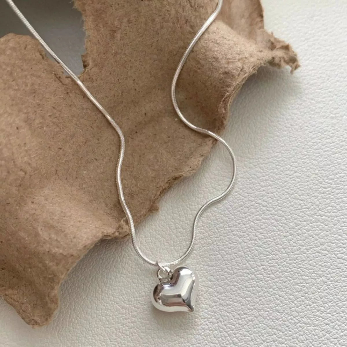 Sterling silver heart necklace from Plush Fashion Hub, featuring a delicate chain and a polished heart pendant.
