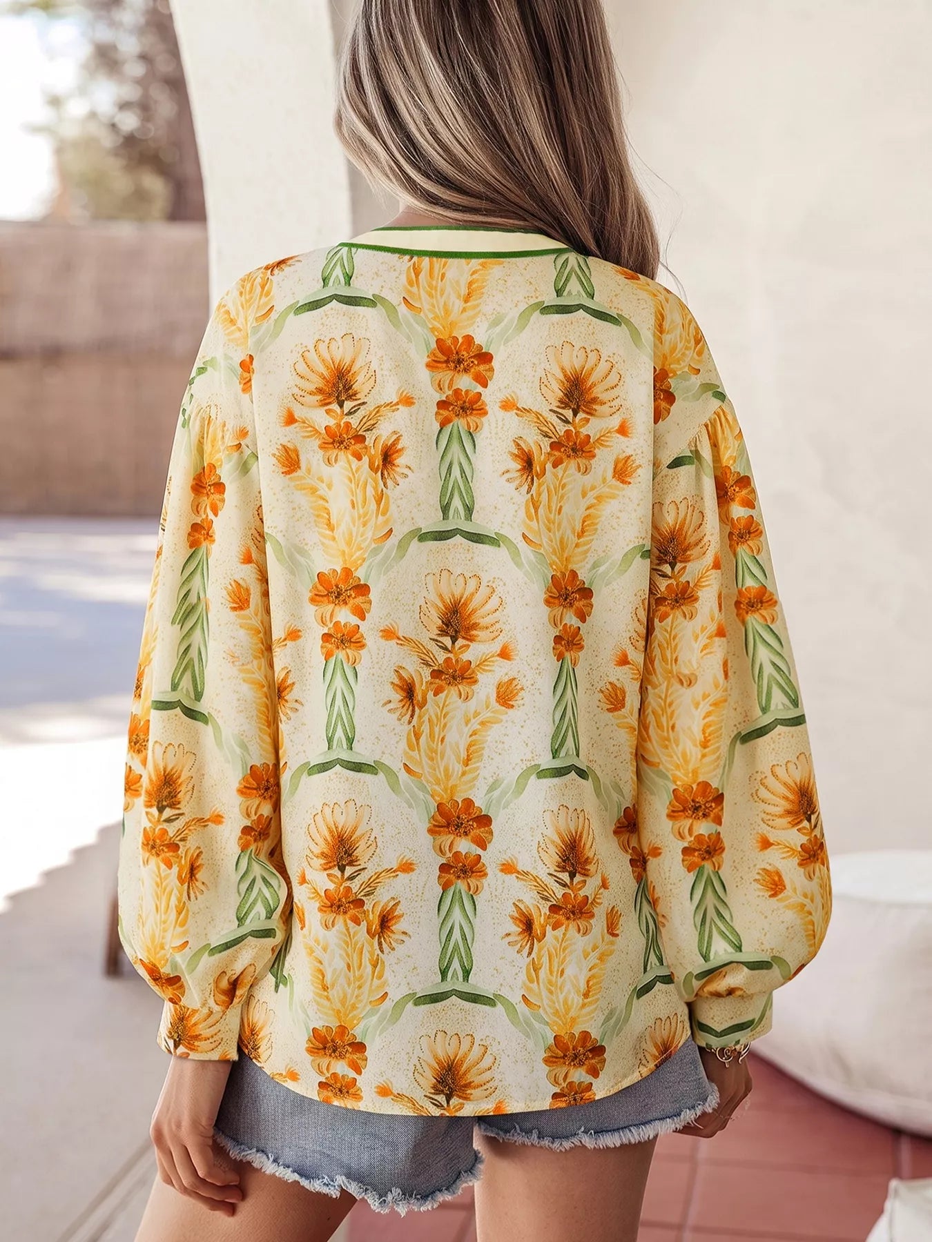 Floral print V-neck long sleeve blouse by Plush Fashion Hub, featuring a colorful floral pattern and lightweight fabric.