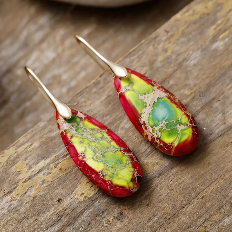 Teardrop-shaped natural stone dangle earrings from Shopimist featuring elegant, polished stone pendants hanging from silver hooks.