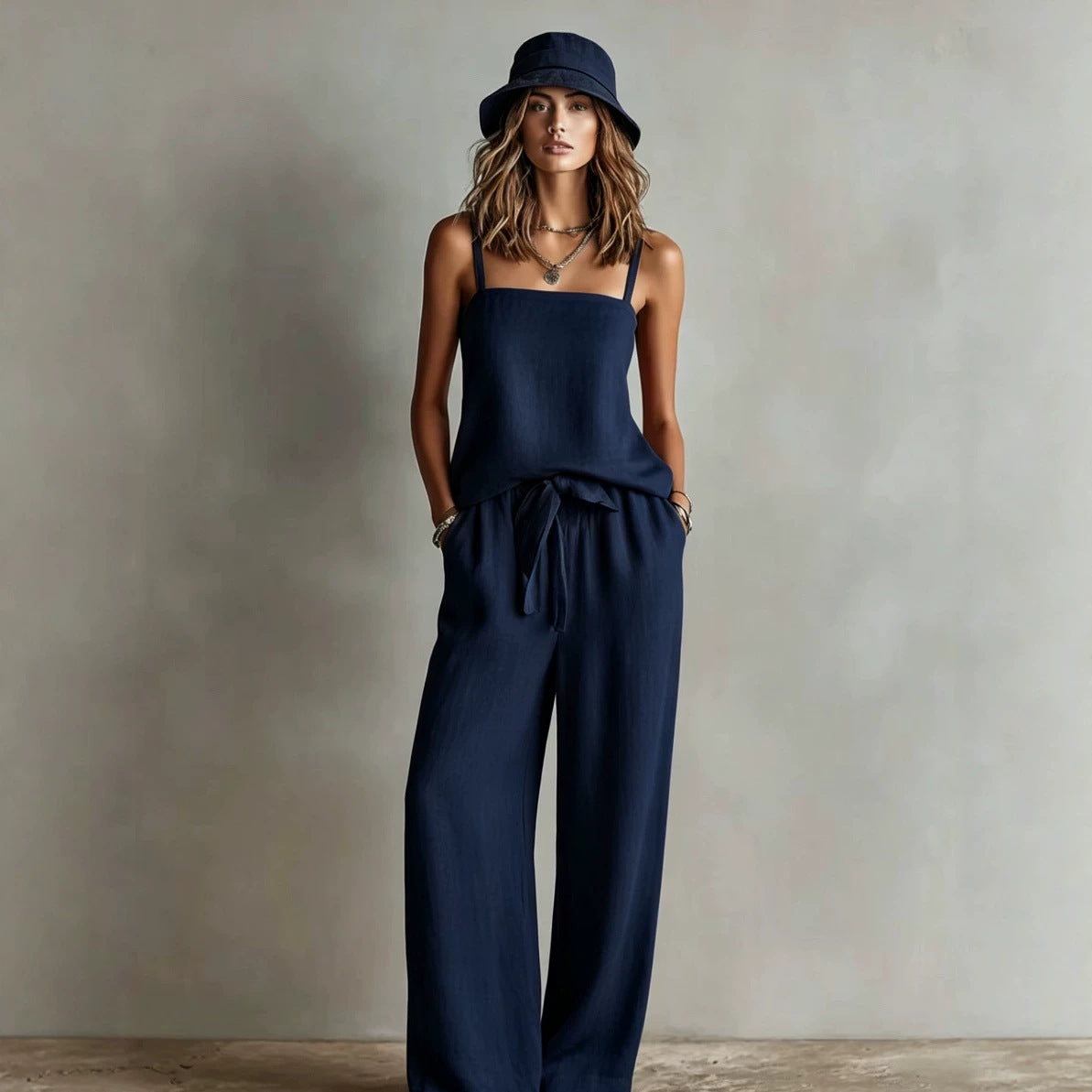 Women's casual two-piece set by FitiqueFit featuring a spaghetti strap cami top and wide-leg pants, perfect for relaxed wear.