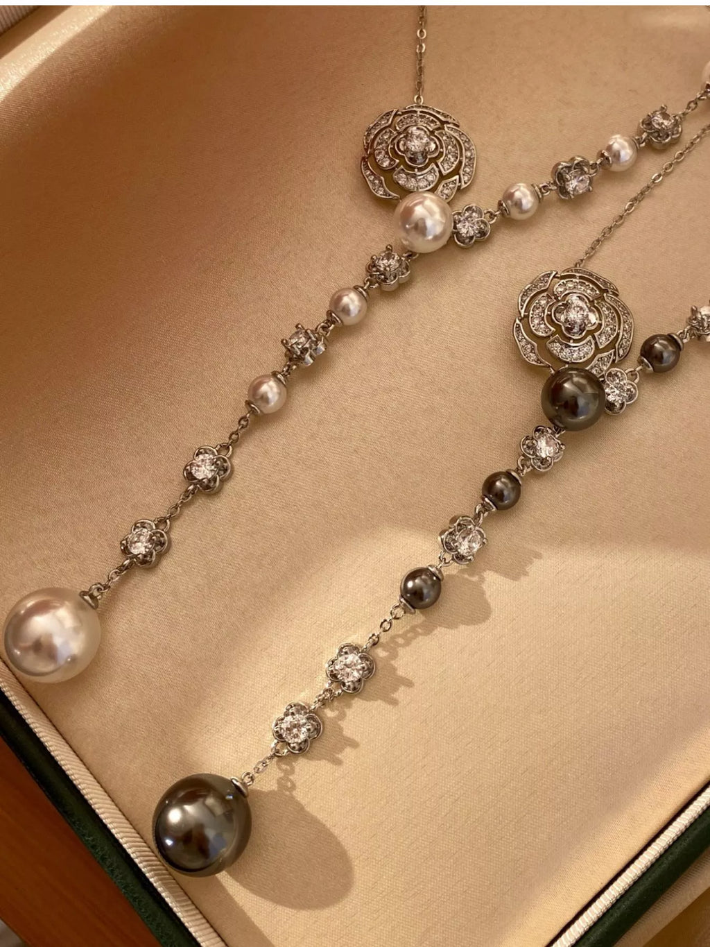 Elegant Pearl Flower Y-necklace by Shopimist featuring a delicate floral design and white pearls on a sleek gold chain.