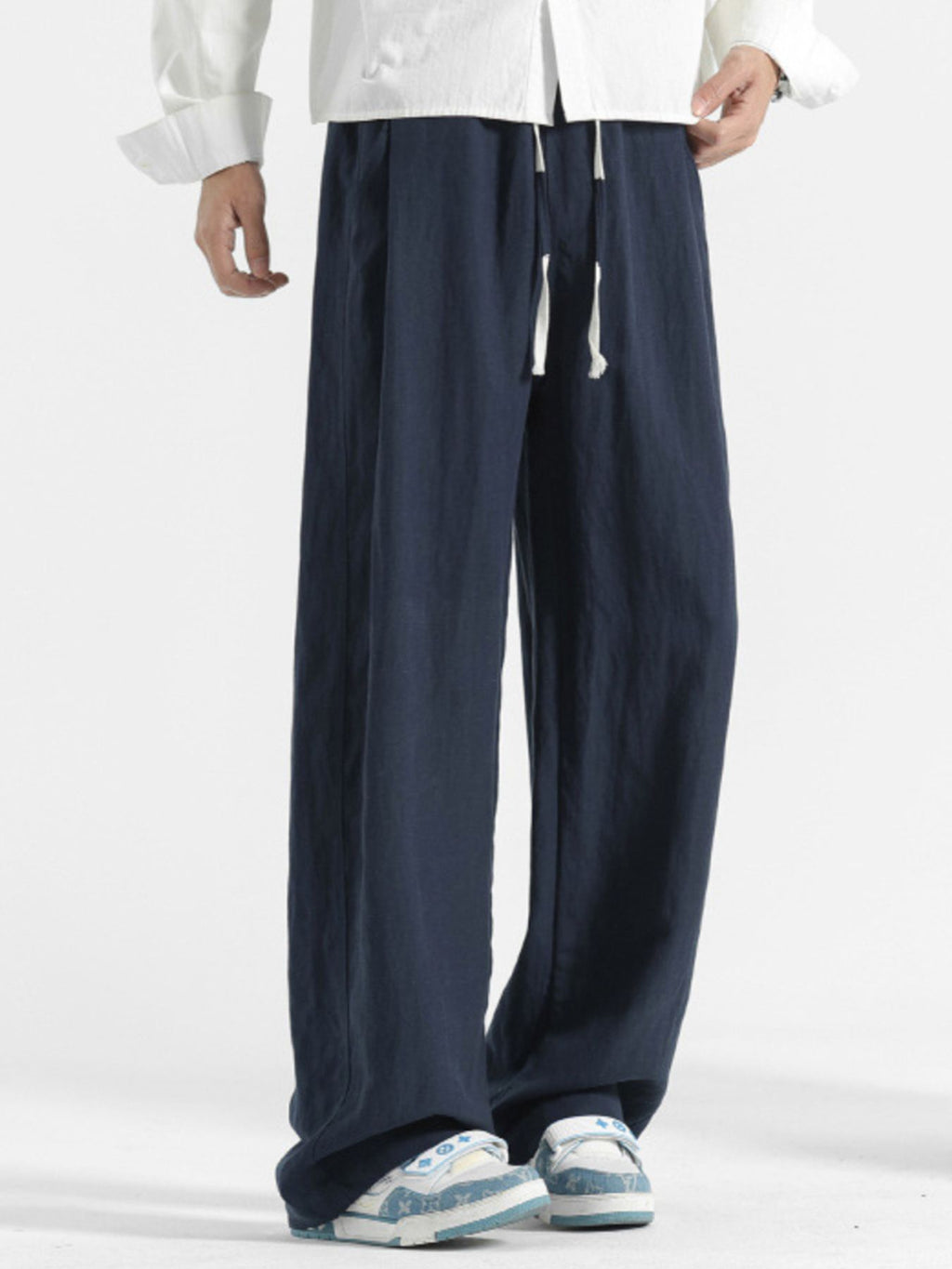 Men's casual loose fit pocket pants by Trendsi, featuring comfortable stretch fabric and relaxed style in a natural pose.