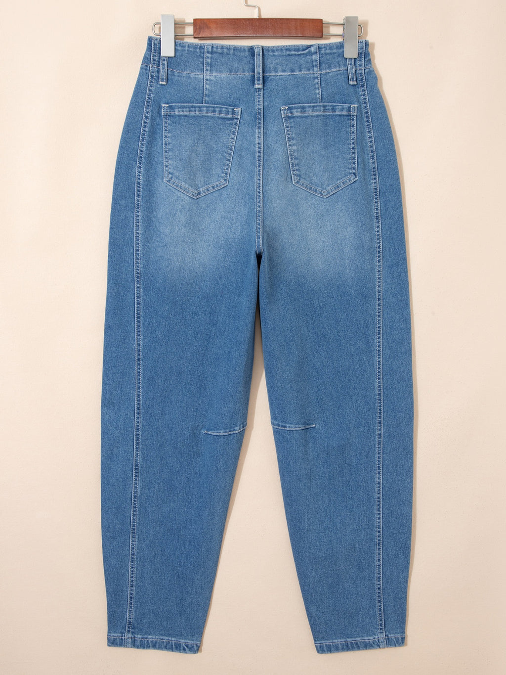 Washed cuffed barrel leg jeans in vintage relaxed fit denim, Trendsi bottoms, displayed on a hanger with a casual style.