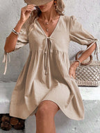Cotton V-neck tie-front mini dress with puff sleeves, stylish and lightweight, from Trendsi, perfect for casual or summer wear.