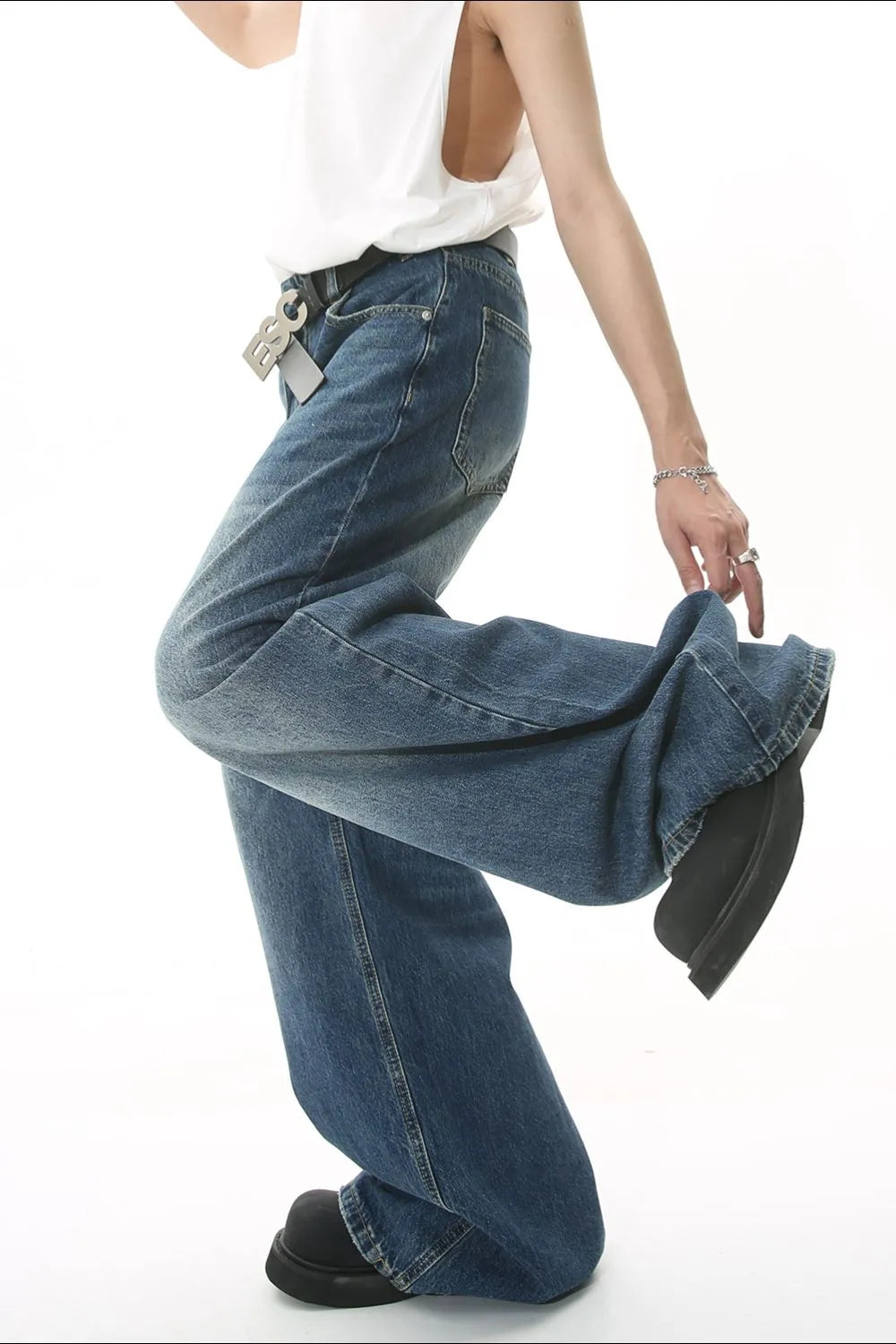 Wide leg jeans with pockets from Trendsi, featuring a relaxed fit and classic denim style, shown on a model.
