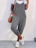 Casual loose fit spaghetti strap jumpsuit with pockets by Trendsi, shown in a relaxed style perfect for everyday wear.