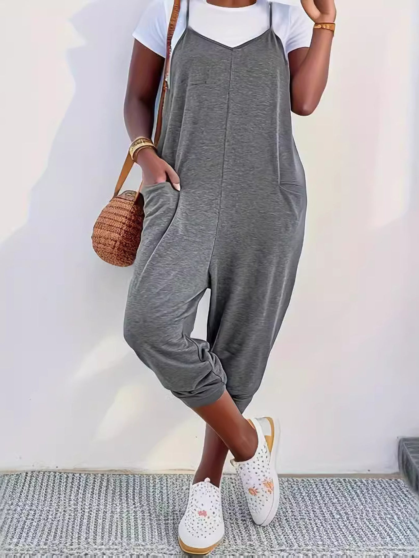 Casual loose fit spaghetti strap jumpsuit with pockets by Trendsi, shown in a relaxed style perfect for everyday wear.