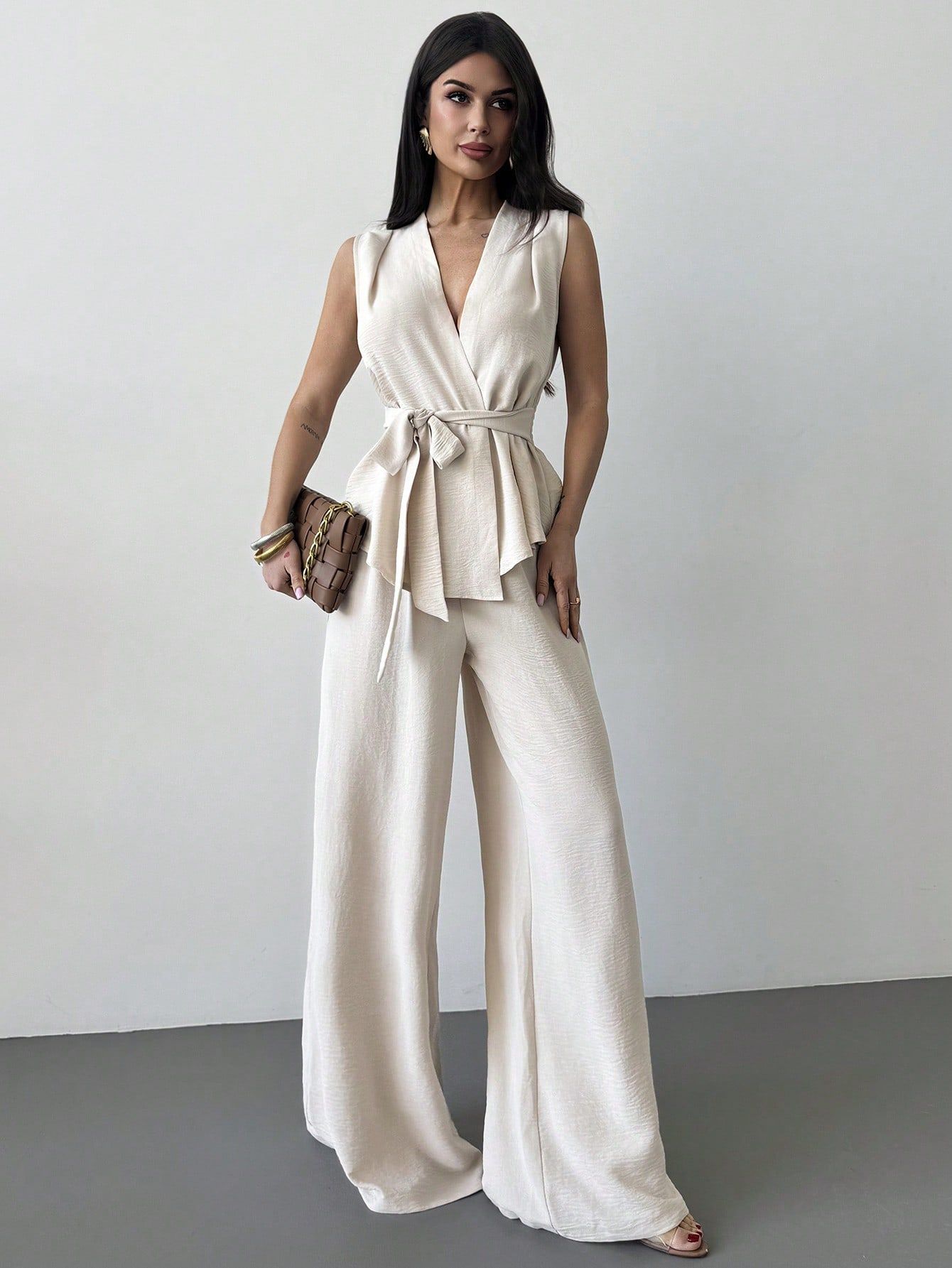 Women's lace-up V-neck vest and matching pants two-piece set by FitiqueFit, featuring a stylish and elegant commuter outfit.