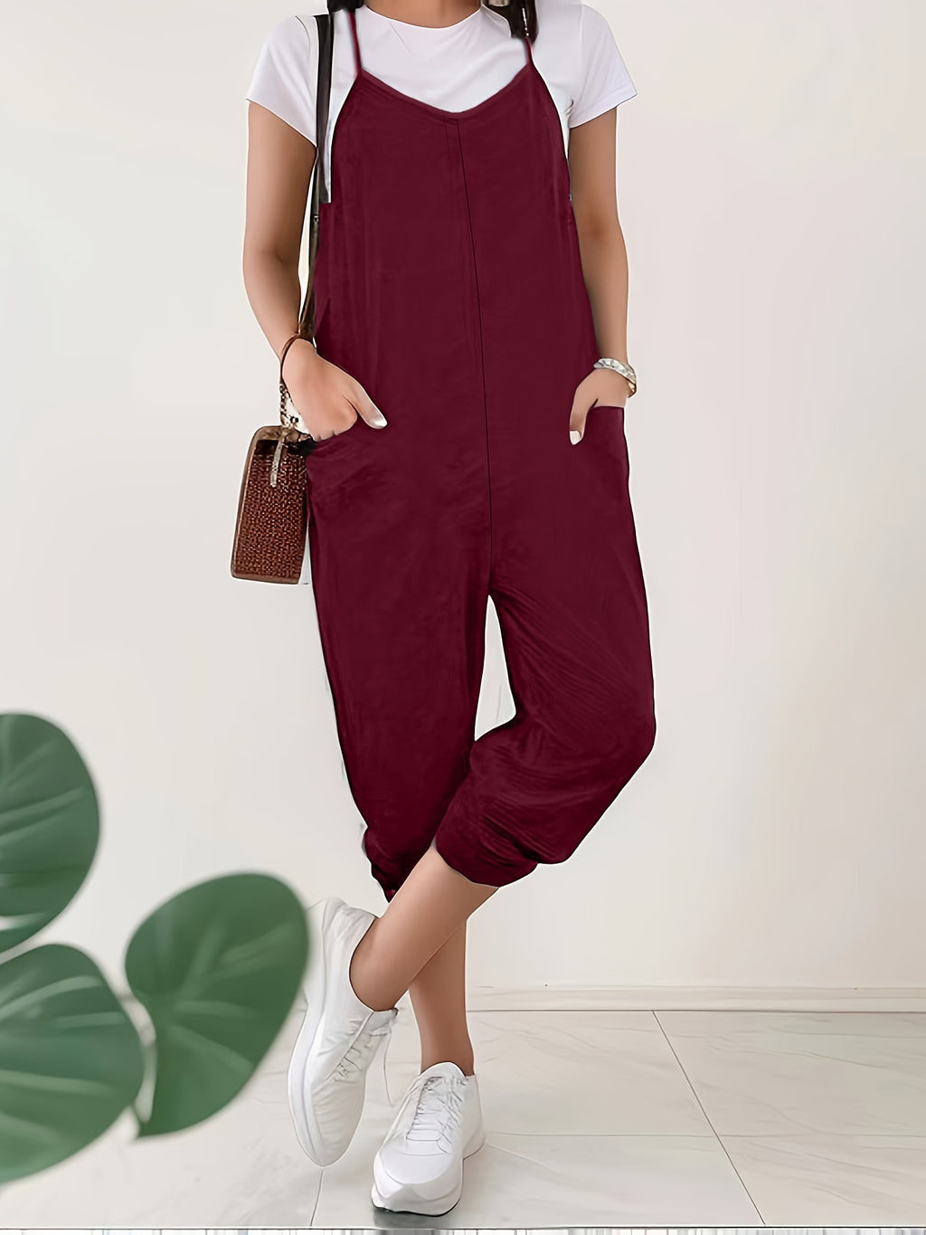 Casual loose fit spaghetti strap jumpsuit with pockets by Trendsi, shown in a light fabric with a relaxed style.