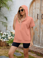 Trendsi half zip short sleeve hooded top in casual athletic style, featuring a front zipper and lightweight fabric.