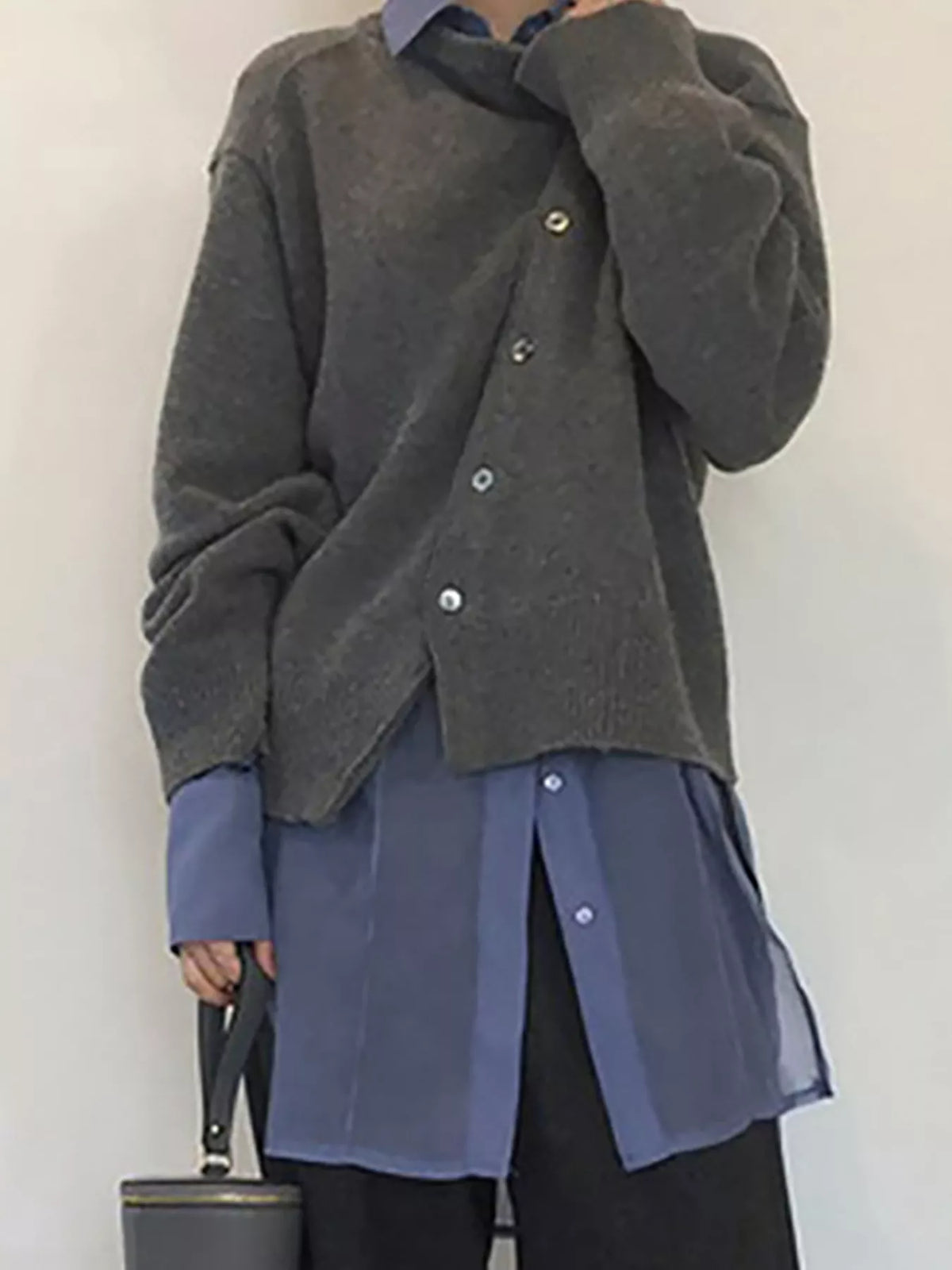 Asymmetric button-down sweater from Trendsi featuring a stylish, modern design with unique button details and a cozy fit.
