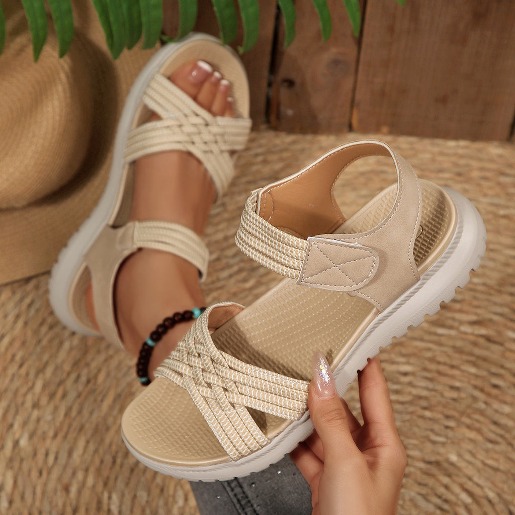 Women's open toe woven strap flat sandals by Trendsi, comfortable faux leather slides with stylish woven design.
