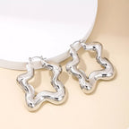 Star-shaped hoop earrings from Shopimist featuring a shiny gold finish and stylish star design for trendy fashion accessory.