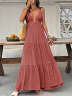 Flowy women's deep V-neck tiered maxi dress by Plush Fashion Hub, featuring smocked bodice and boho beach-inspired style.