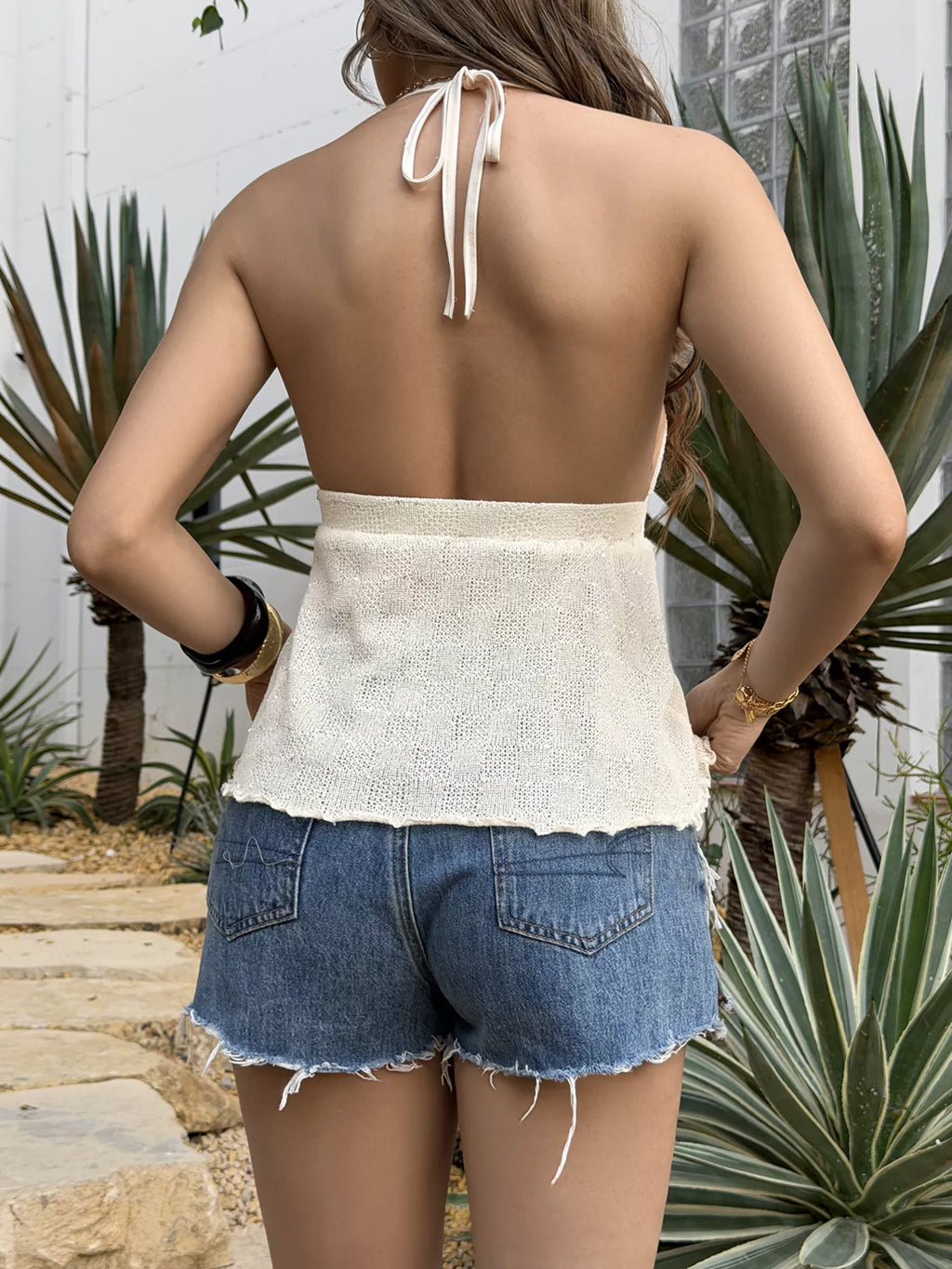 Shell halter neck cami top from Trendsi featuring a woven shell pattern and halter strap, perfect for stylish summer outfits.