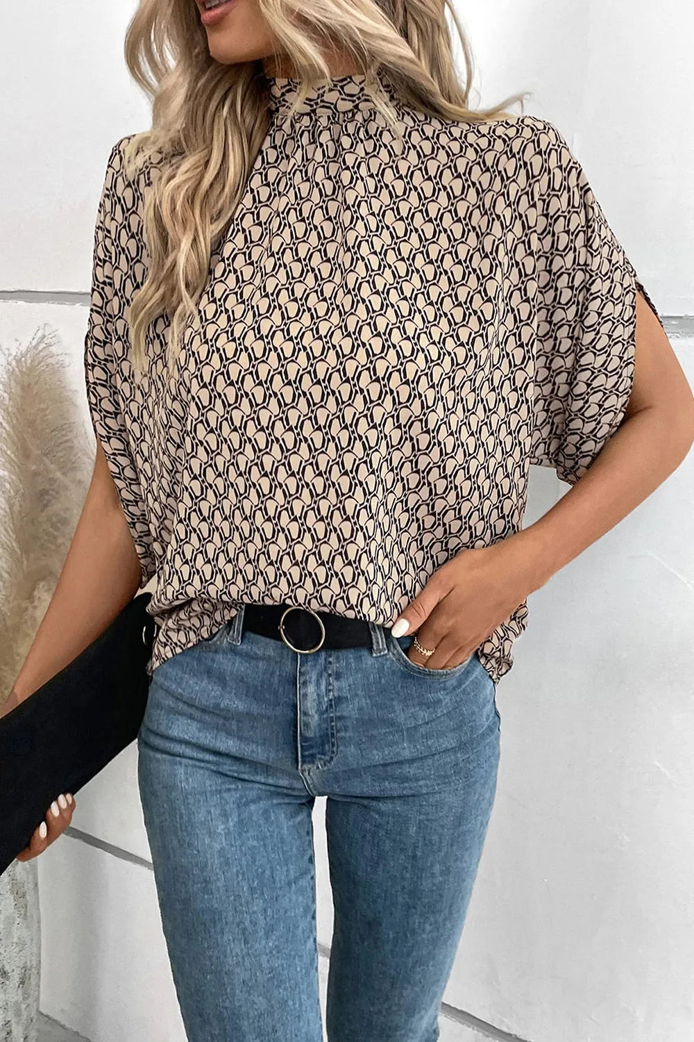 Plush Fashion Hub elegant tie-back half-sleeve blouse with side slit, featuring a stylish design and lightweight fabric.