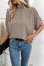 Plush Fashion Hub elegant tie-back half-sleeve blouse with side slit, featuring a stylish design and lightweight fabric.