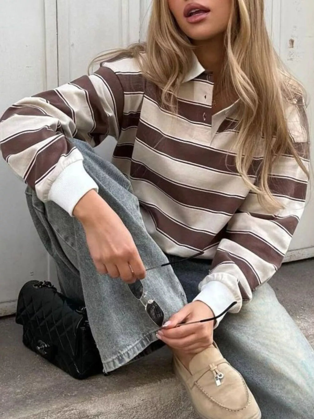 Striped button detail long sleeve polo shirt from Trendsi, featuring a classic design with striped pattern and button accents.