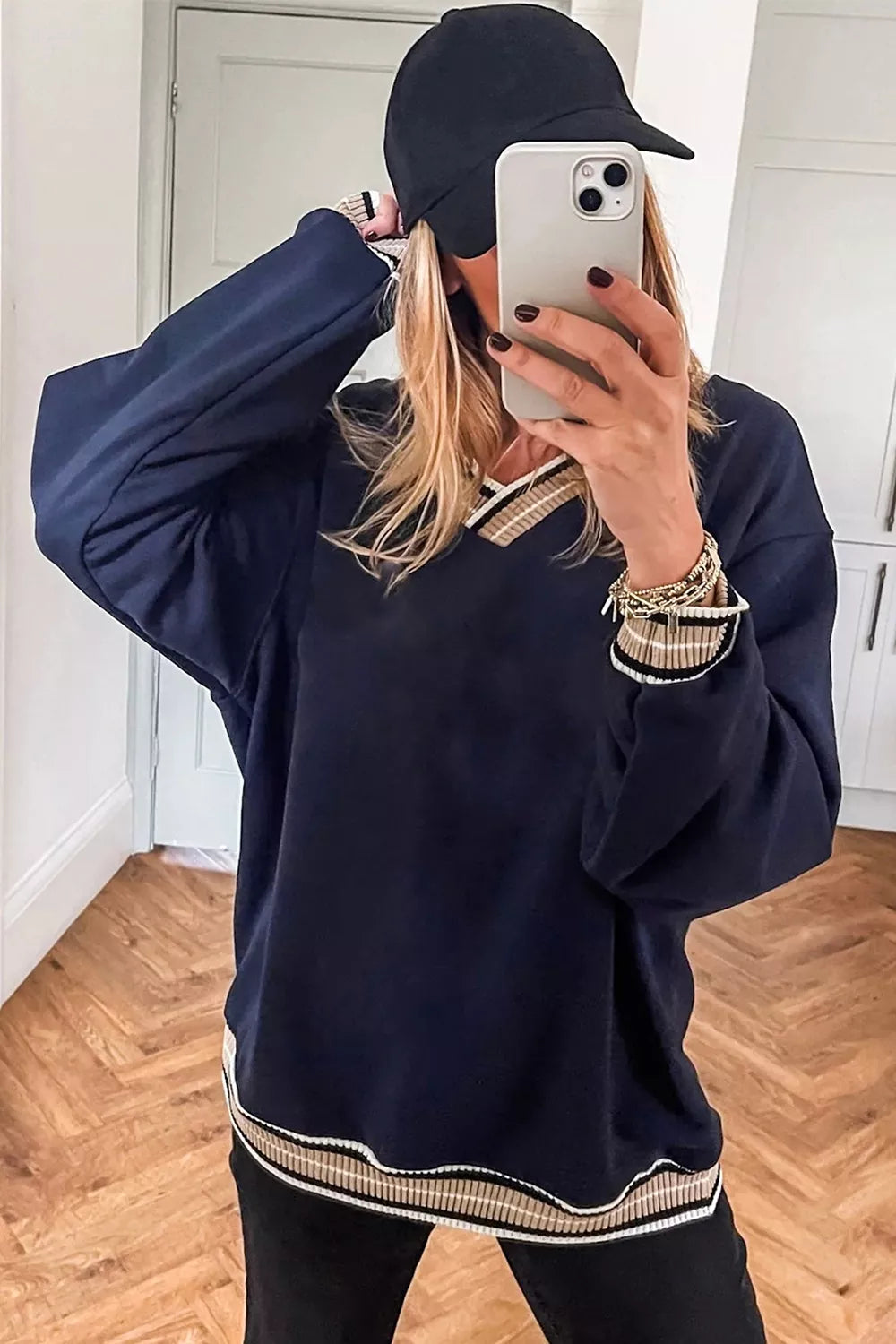 Contrast striped trim V-neck sweatshirt from Trendsi featuring color-blocked design and long sleeves.