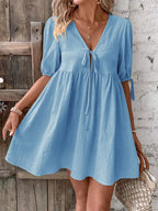 Cotton V-neck tie-front mini dress with puff sleeves, stylish and lightweight, from Trendsi.