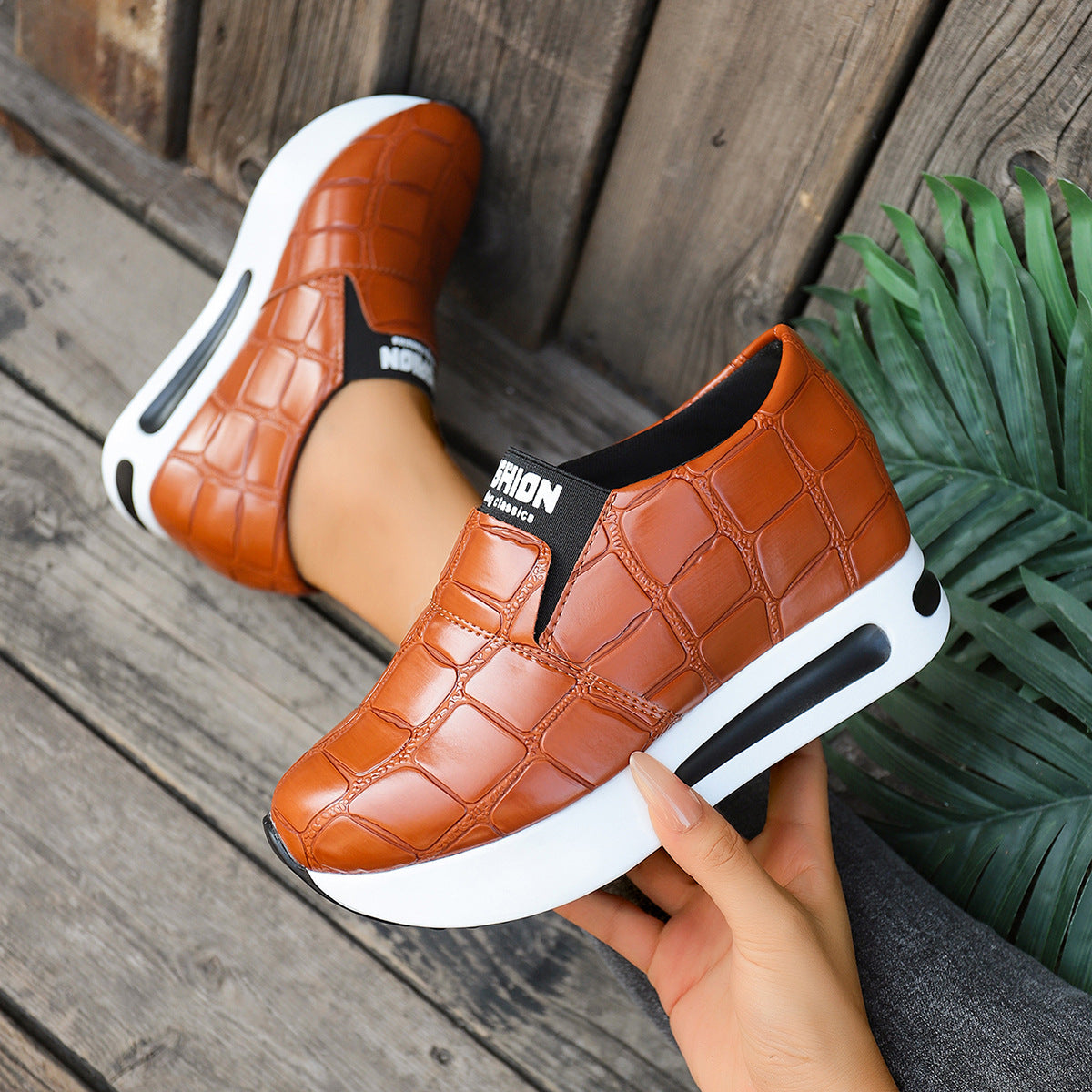 Women's crocodile pattern faux leather platform slip-on sneakers, casual trendy shoes by Trendsi featuring a sleek design.