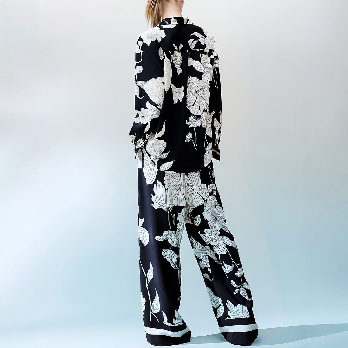 Black and white floral two-piece set by eprolo featuring stylish crop tops with a vibrant floral pattern.