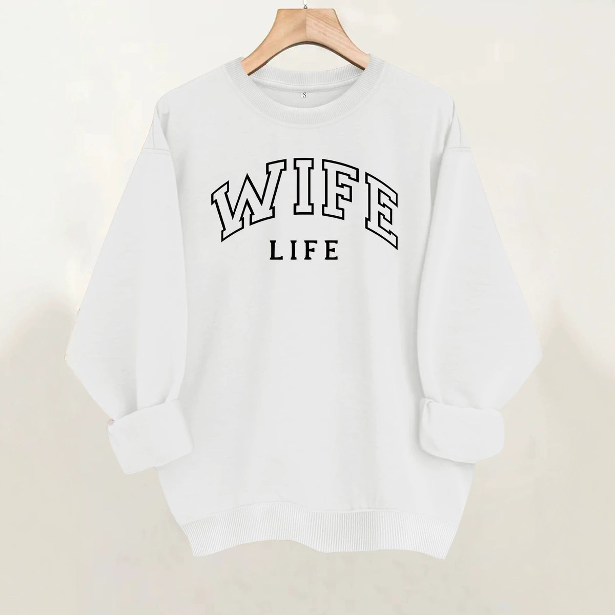 White crewneck sweatshirt with "WIFE LIFE" printed in black, arched collegiate lettering across the chest.