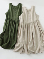 Women's sleeveless V-neck midi dress by Trendsi, made of 100% cotton with button details, casual style, shown in the image.