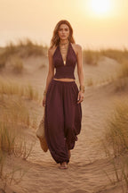 Women's sleeveless backless halter top and wide-leg pants set by FitiqueFit, featuring a stylish, relaxed fit with modern design.
