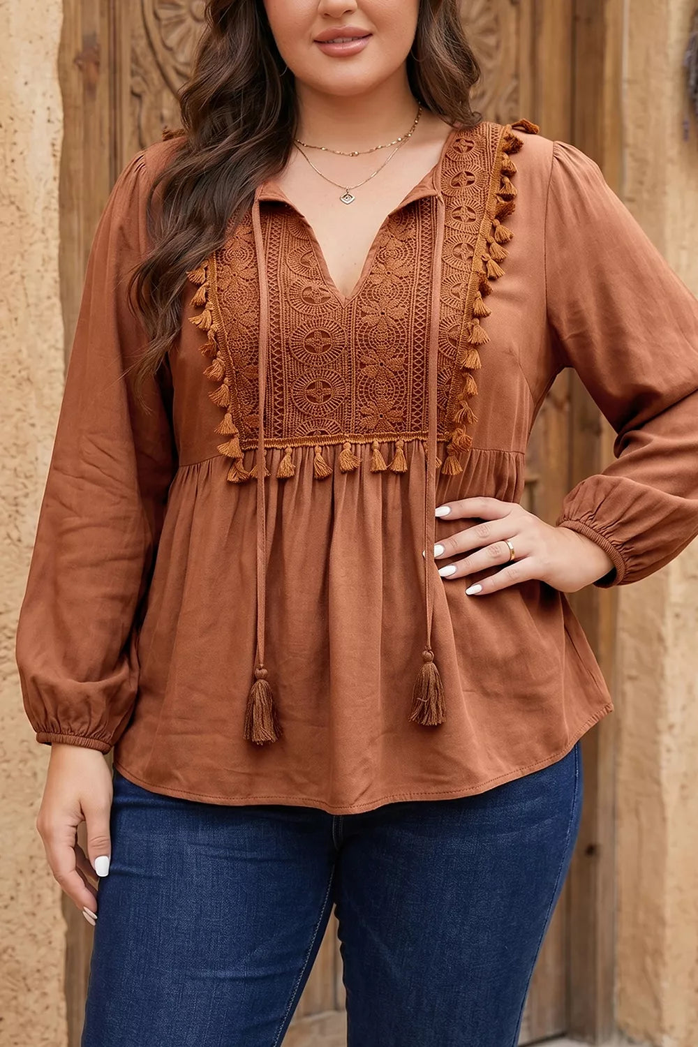 Plus size V-neck embroidered tassel long sleeve blouse from Trendsi, featuring intricate embroidery and flowing fabric.