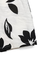 Women's printed halter neck maxi dress with tie-back detail by Plush Fashion Hub, featuring vibrant floral patterns and flowing fabric.