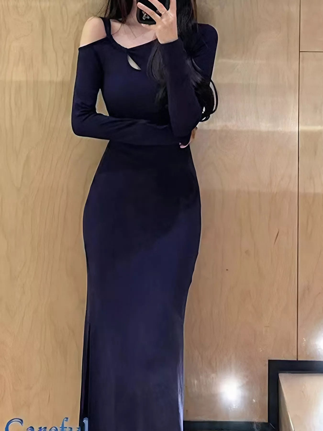 Black asymmetrical cutout long sleeve midi dress by Trendsi featuring a sleek stretch bodycon fit and stylish design.