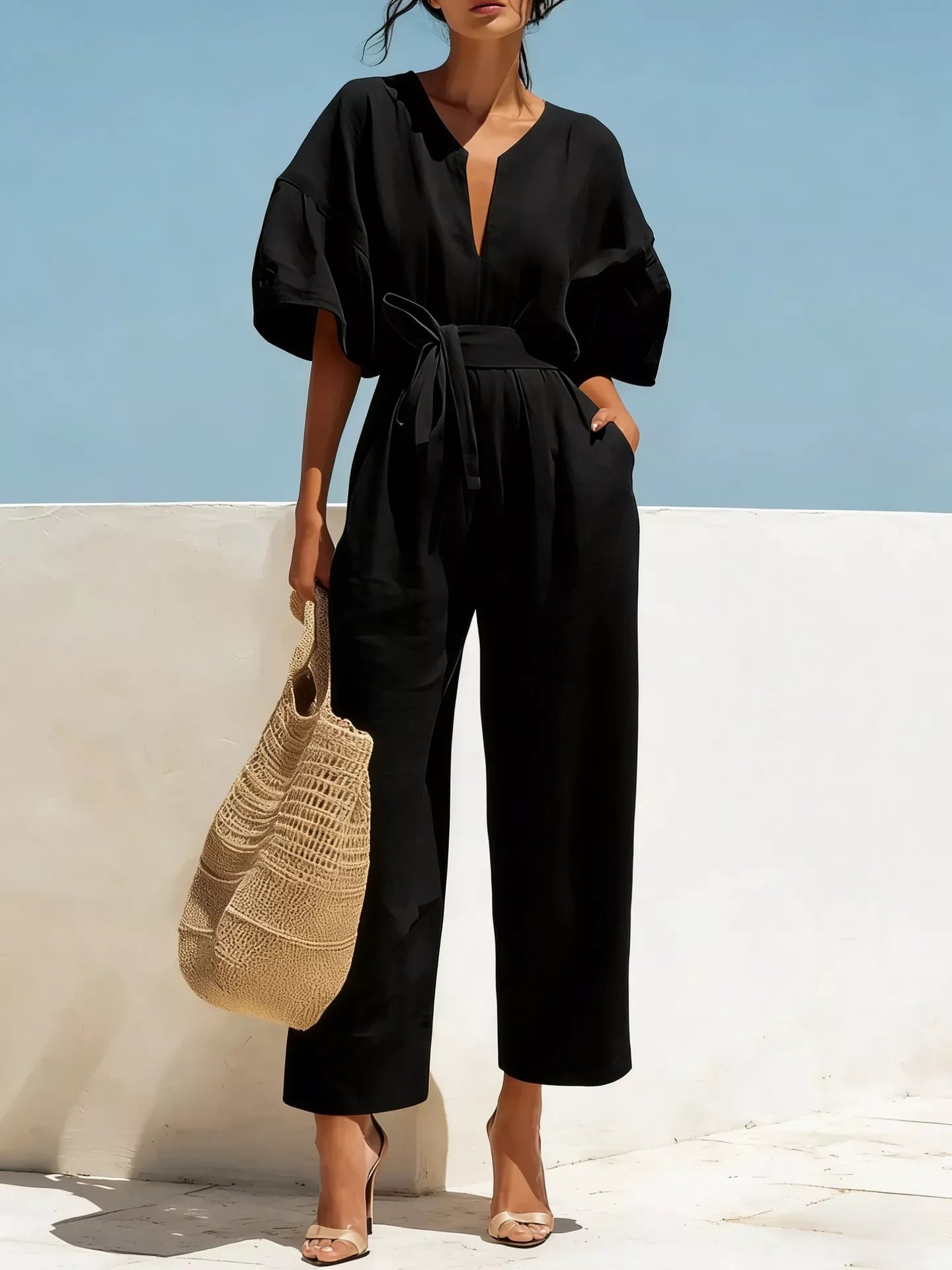 Trendsi tie waist wide-leg bodysuit featuring a fitted top and flowing pants, styled with a sleek, modern look.