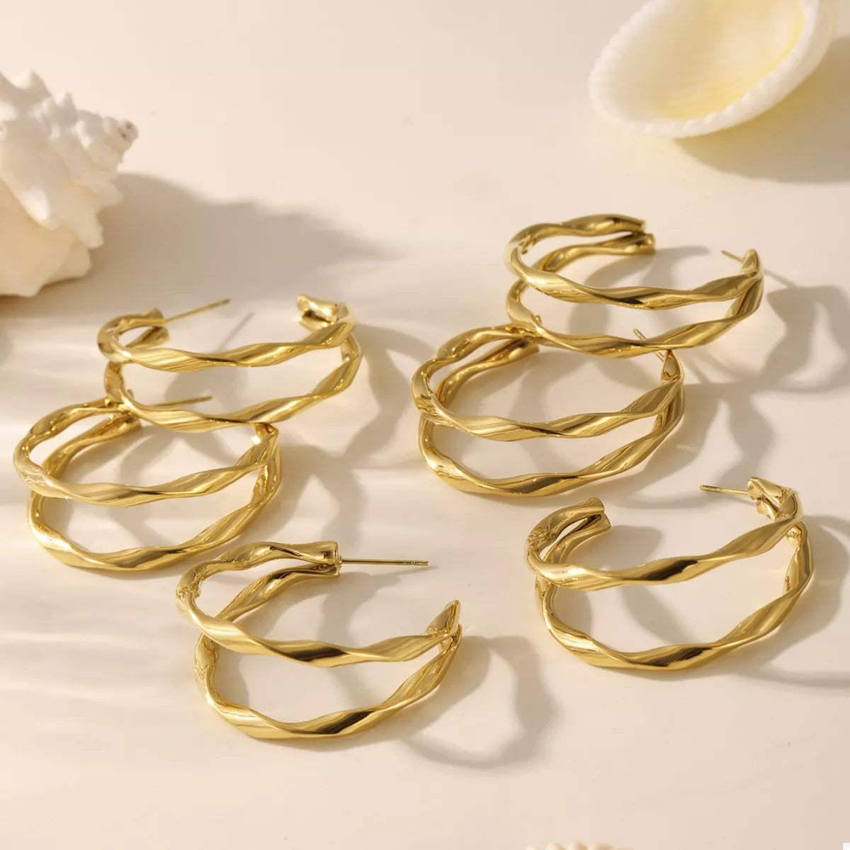 18K gold-plated chunky twisted hoop earrings with a bold, stylish design by Plush Fashion Hub.