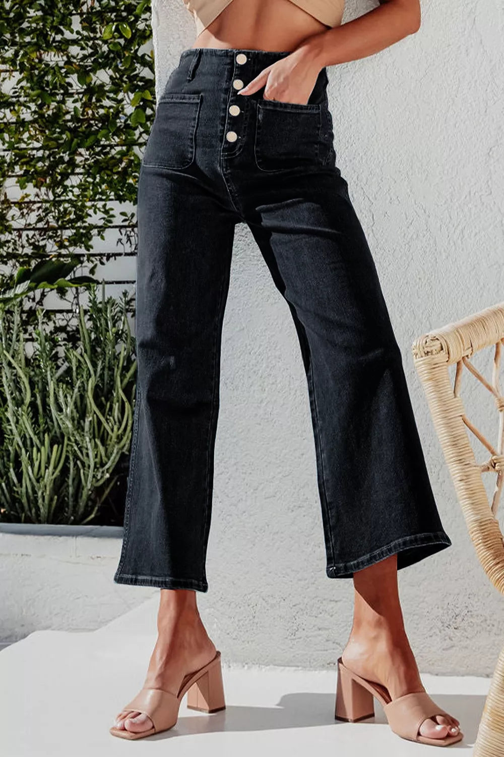 High-waisted button-fly wide-leg jeans by Trendsi, showing the denim with front buttons and relaxed fit on a model.