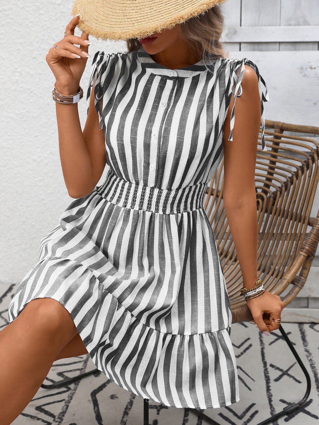 Women's striped smocked summer dress with ruffle hem by Trendsi, featuring a sleeveless design and lightweight fabric.
