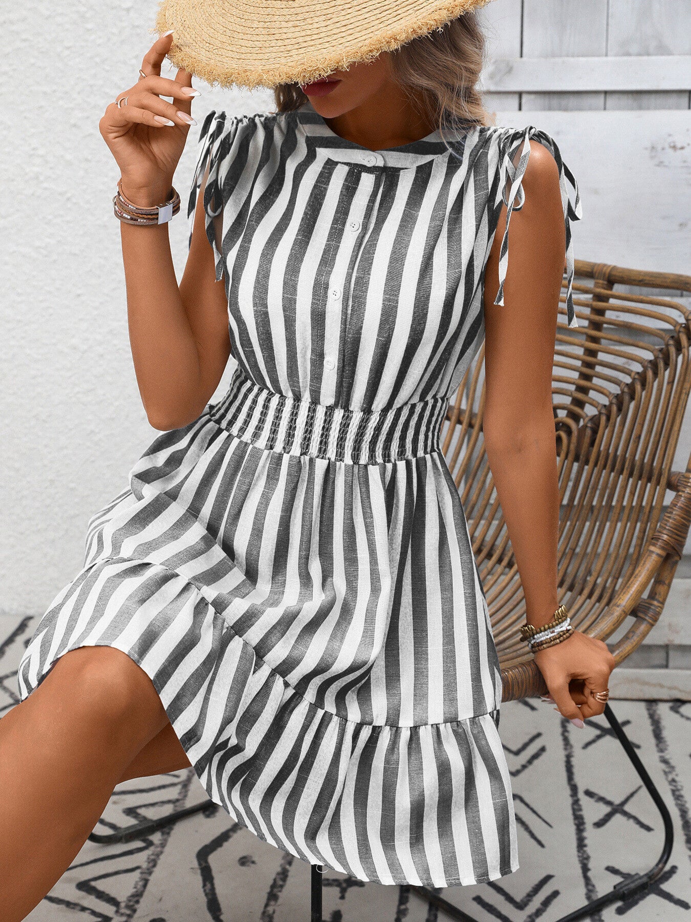 Women's striped smocked summer dress with ruffle hem by Trendsi, featuring a sleeveless design and lightweight fabric.
