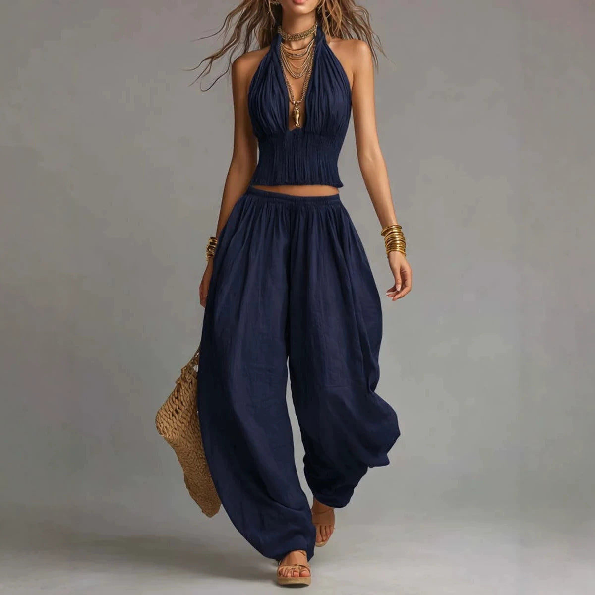 Women's sleeveless backless halter top and wide-leg pants set by FitiqueFit, featuring a stylish, coordinated outfit with modern design.